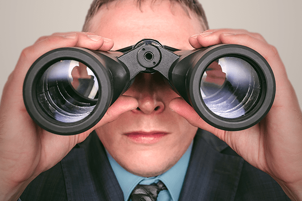 Person looking through binoculars