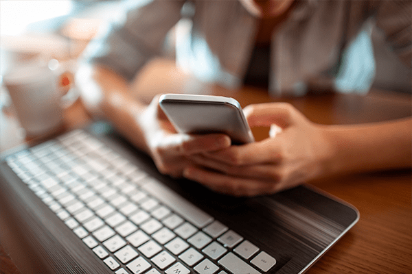 Person typing on phone